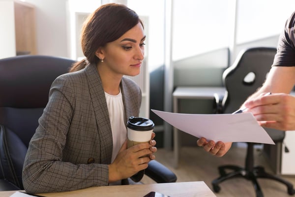 businesswoman-looking-papers-office